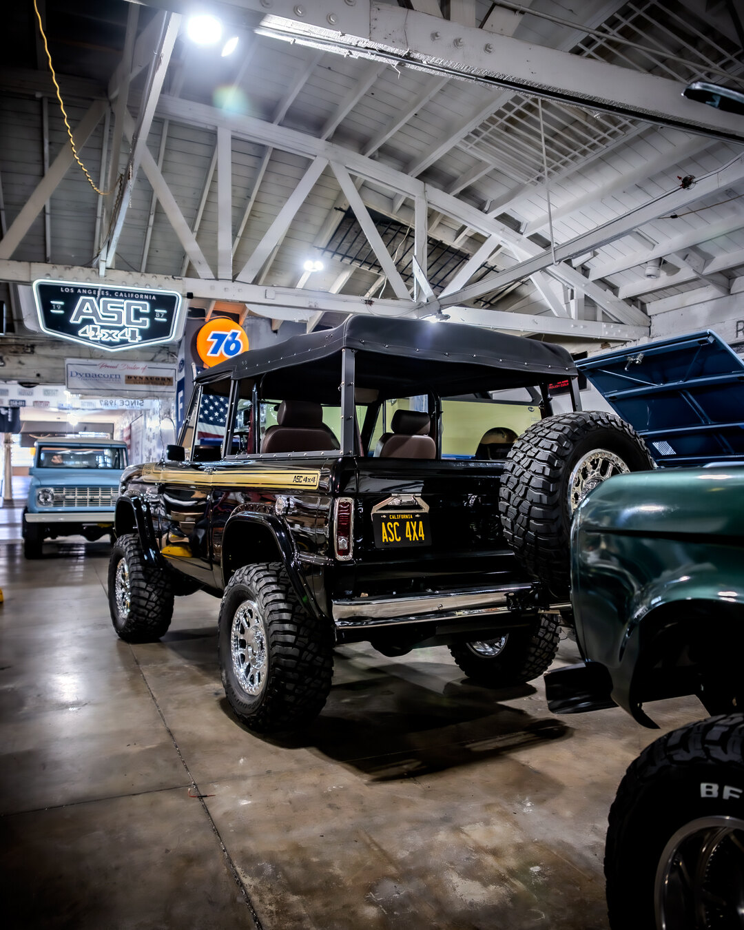 Rear view of a vintage Ford Bronco inside the ASC 4x4 shop